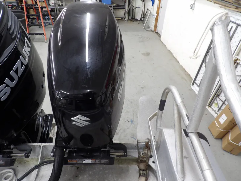 Slide: The Image of 2005 SAFE Boats Defender 25 with Suzuki outboard motor in a workshop setting. - 27