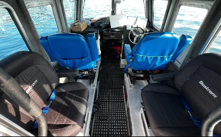 Slide: The Image of Interior of 2005 SAFE Boats Defender 25 with blue and black seating. - 3