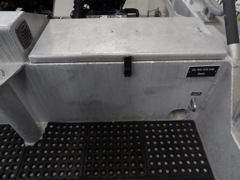 Slide: The Image of Interior view of a 2005 SAFE Boats Defender 25 with metal flooring and storage compartment. - 30