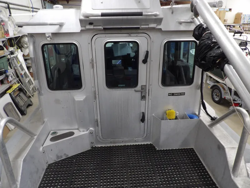 Slide: The Image of 2005 SAFE Boats Defender 25 interior, featuring sturdy metal construction and secure cabin door. - 32