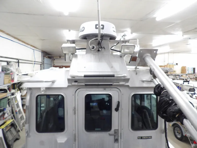 Slide: The Image of 2005 SAFE Boats Defender 25 in a garage, showcasing radar and equipment. - 33