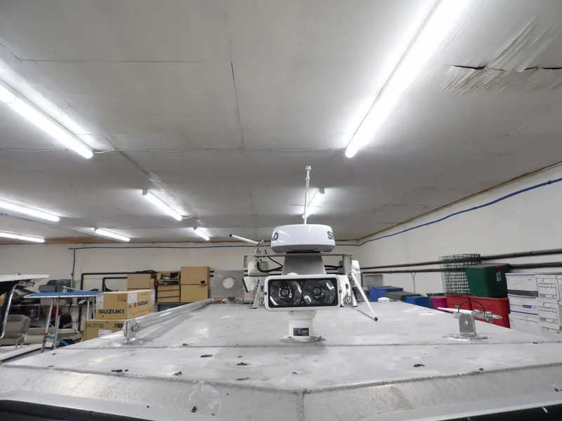 Slide: The Image of 2005 SAFE Boats Defender 25 in a well-lit storage facility. - 34