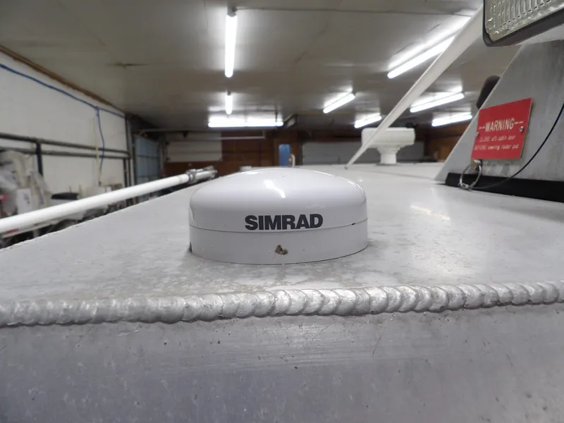 Slide: The Image of Simrad device on 2005 SAFE Boats Defender 25 in a garage setting. - 37