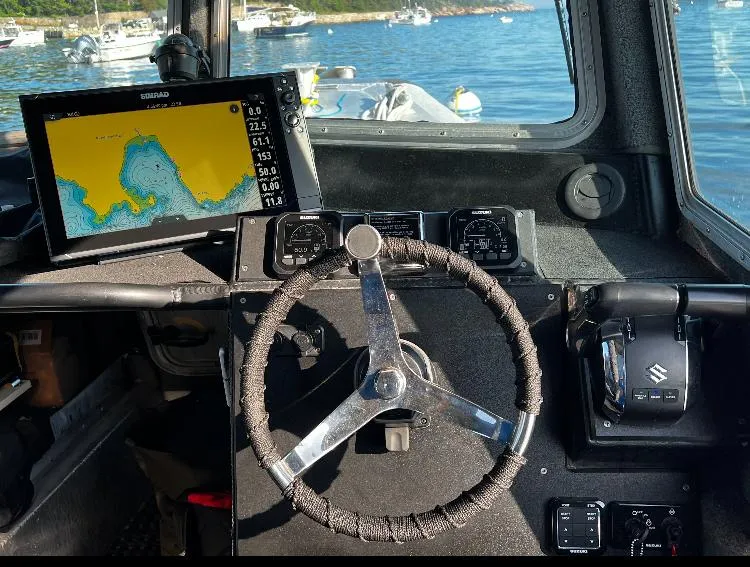 Slide: The Image of Interior of 2005 SAFE Boats Defender 25 with navigation system and steering wheel. - 4