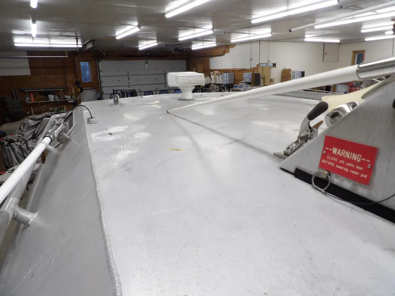 Slide: The Image of 2005 SAFE Boats Defender 25 in a garage, showcasing deck and equipment. - 41