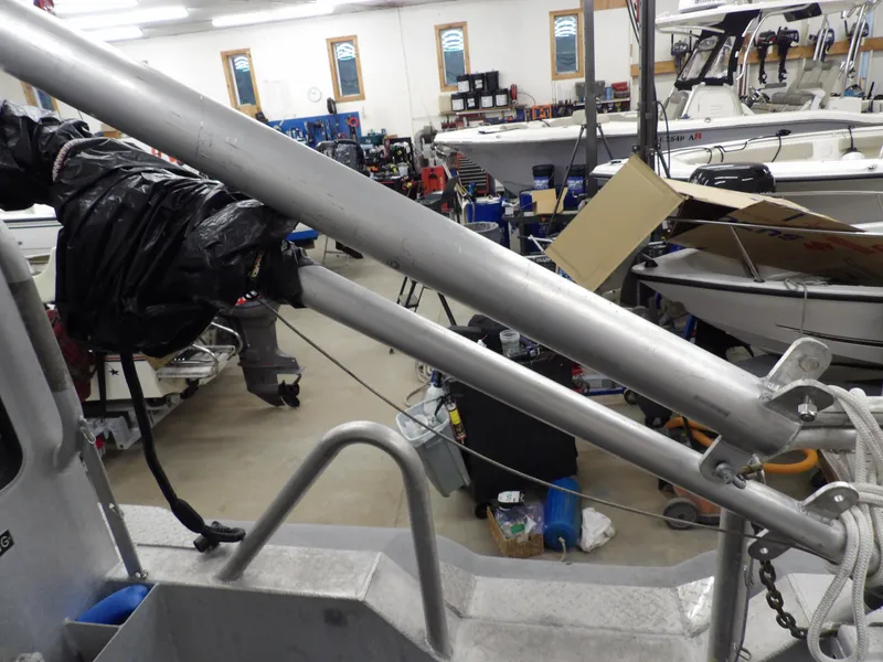 Slide: The Image of 2005 SAFE Boats Defender 25 in a workshop, surrounded by equipment and other boats. - 47