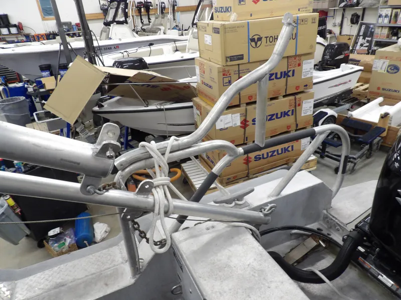 Slide: The Image of SAFE Boats Defender 25, 2005 model, in a workshop with Suzuki boxes. - 48