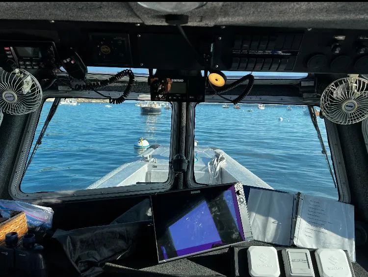 Slide: The Image of Interior view of 2005 SAFE Boats Defender 25, showing navigation equipment and ocean scenery. - 6