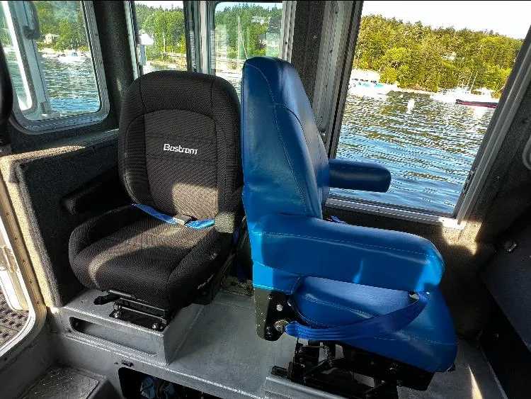 Slide: The Image of Interior seating of 2005 SAFE Boats Defender 25, featuring Bostrom seats with scenic water view. - 7