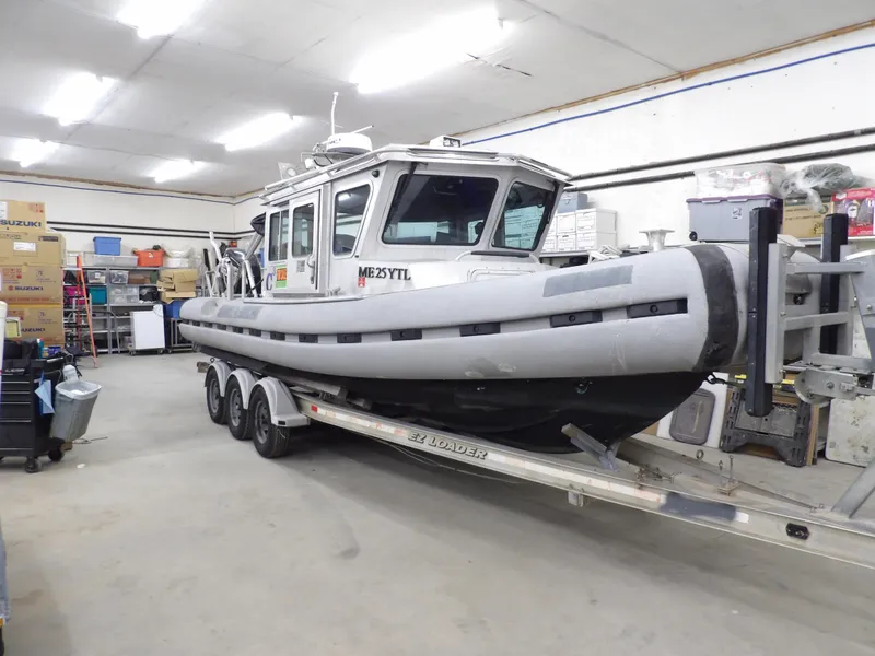 Slide: The Image of 2005 SAFE Boats Defender 25 on trailer in storage facility. - 8