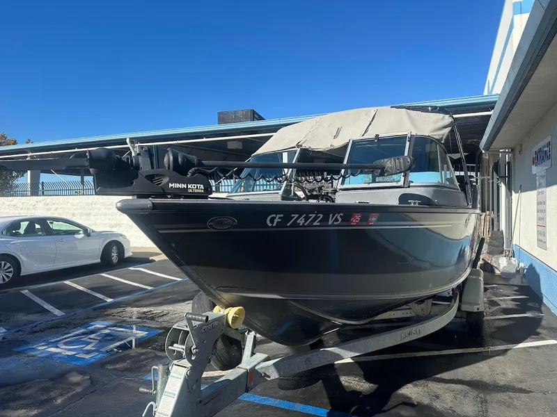 Slide: The Image of 2019 Lund 2000 Sport Angler boat on trailer in parking lot. - 10