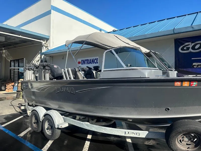 Slide: The Image of 2019 Lund 2000 Sport Angler boat on trailer outside a building. - 12