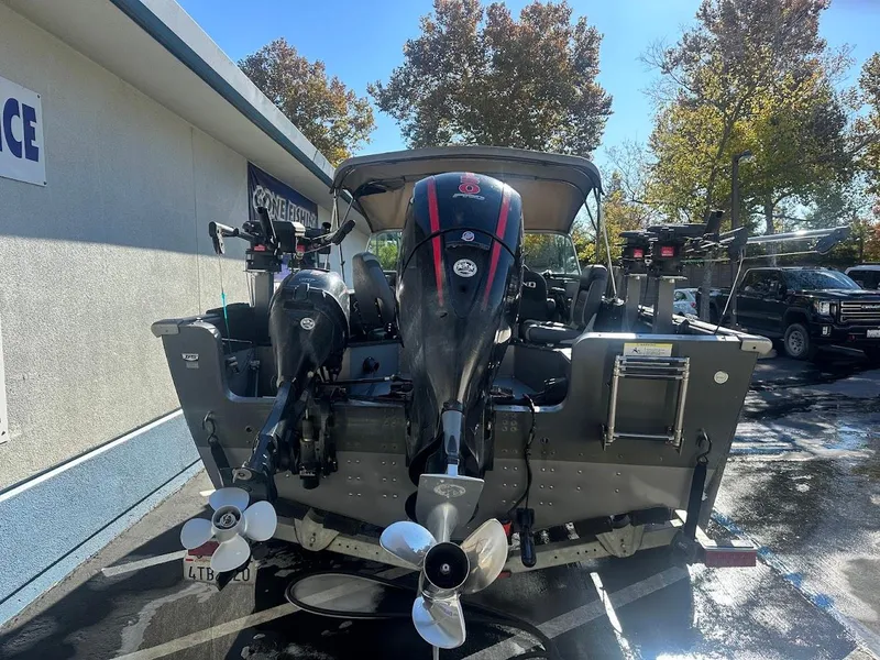 Slide: The Image of 2019 Lund 2000 Sport Angler boat with dual outboard motors, parked outdoors. - 15