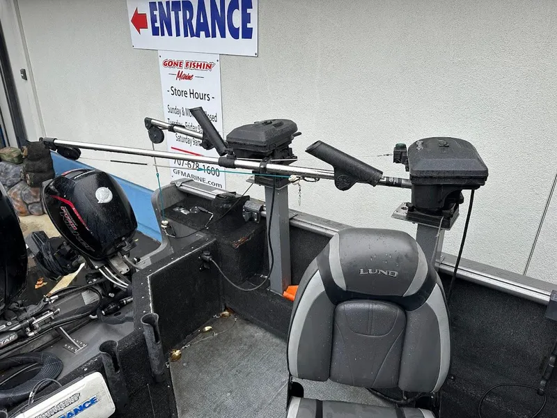 Slide: The Image of 2019 Lund 2000 Sport Angler boat interior with fishing equipment and seating. - 18