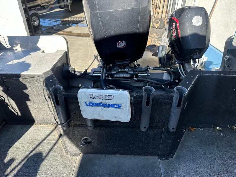 Slide: The Image of 2019 Lund 2000 Sport Angler boat interior with Lowrance equipment and Mercury outboard motors. - 20