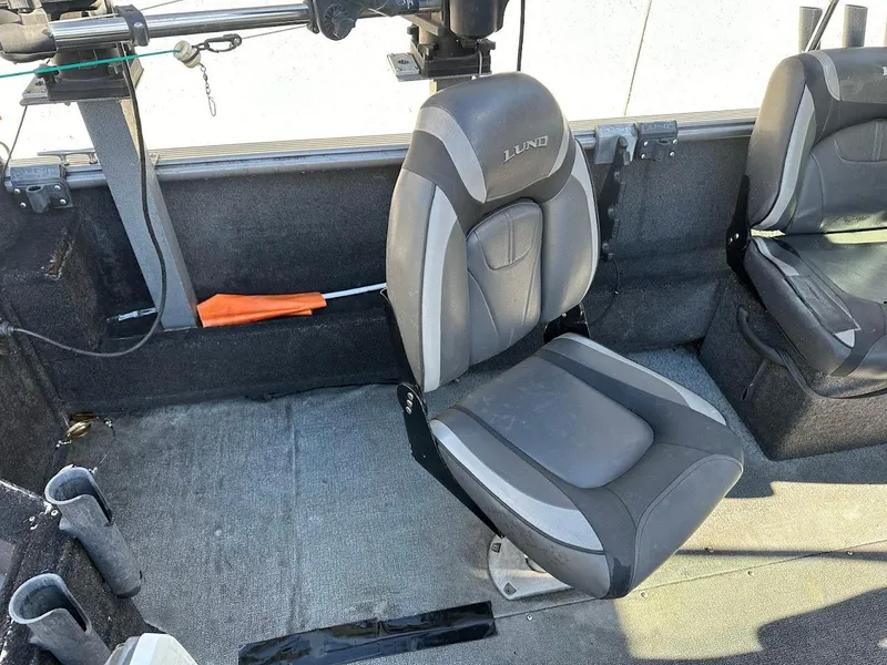 Slide: The Image of 2019 Lund 2000 Sport Angler boat interior with gray seating and fishing rod holder. - 22