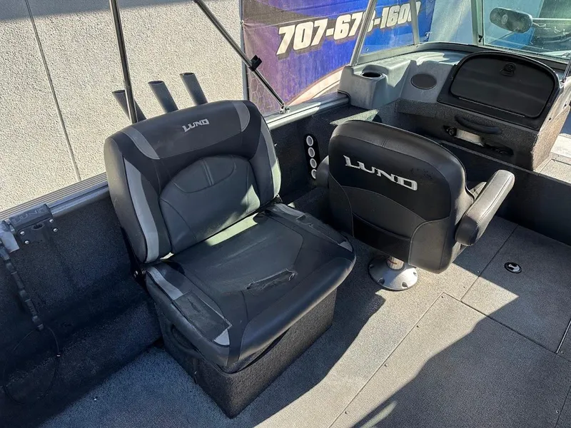 Slide: The Image of 2019 Lund 2000 Sport Angler boat interior with two black seats. - 23