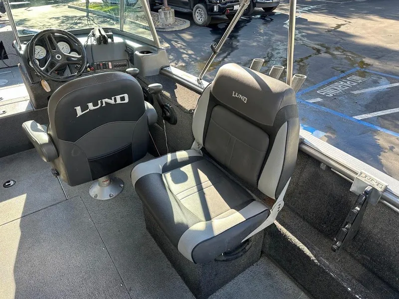 Slide: The Image of 2019 Lund 2000 Sport Angler boat interior with two seats and steering wheel. - 24