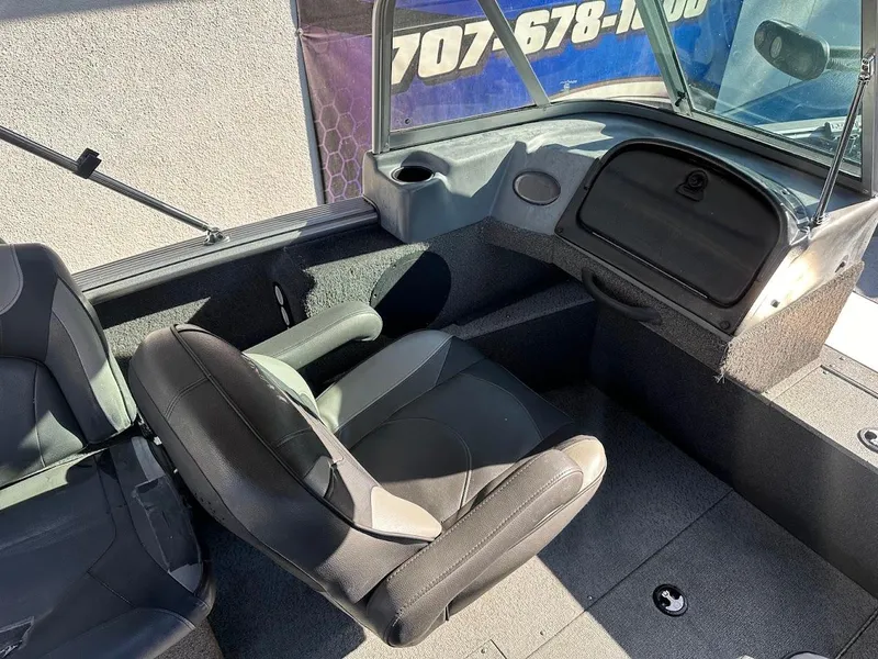 Slide: The Image of 2019 Lund 2000 Sport Angler boat interior with seating and dashboard. - 26