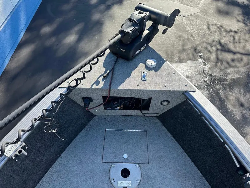 Slide: The Image of 2019 Lund 2000 Sport Angler boat deck with trolling motor and storage compartment. - 32