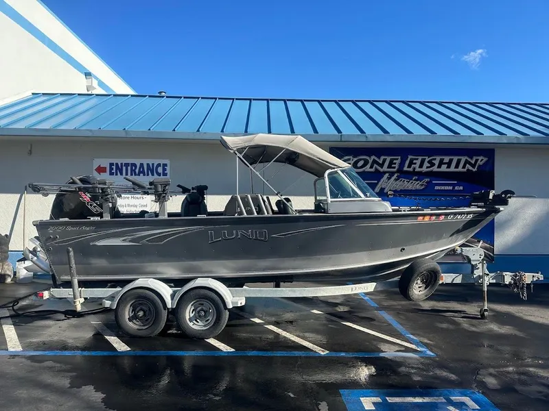 Slide: The Image of 2019 Lund 2000 Sport Angler boat on trailer outside a fishing store. - 7