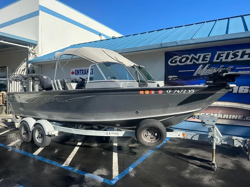 Slide: The Image of 2019 Lund 2000 Sport Angler boat on trailer outside marine store. - 8