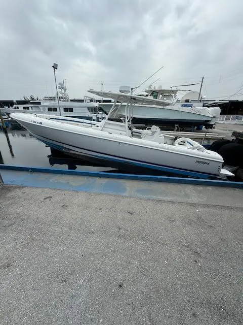 The Image of 2008 Intrepid Open boat docked at marina under cloudy sky. - 1