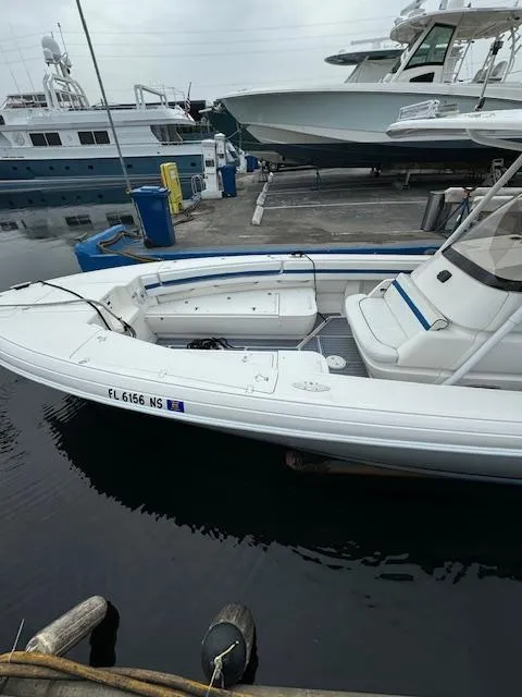 Slide: The Image of 2008 Intrepid Open boat docked at marina, white hull, calm water. - 4