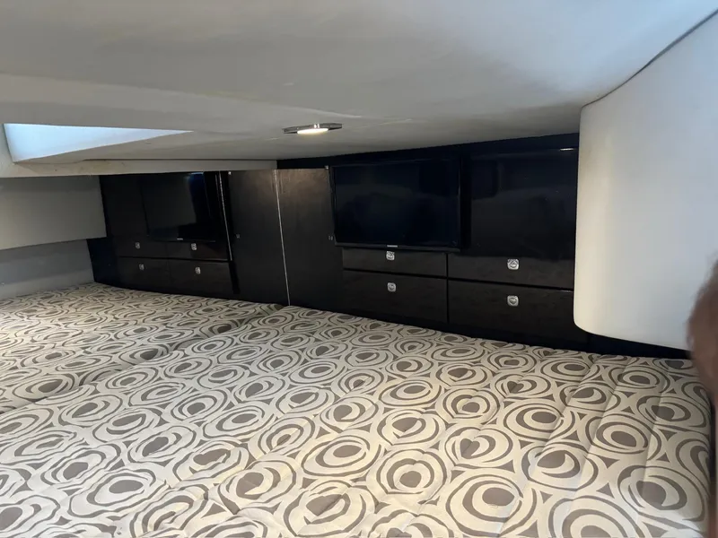 Slide: The Image of Interior of 2017 Formula 400 Super Sport yacht with patterned bedding and sleek cabinetry. - 22