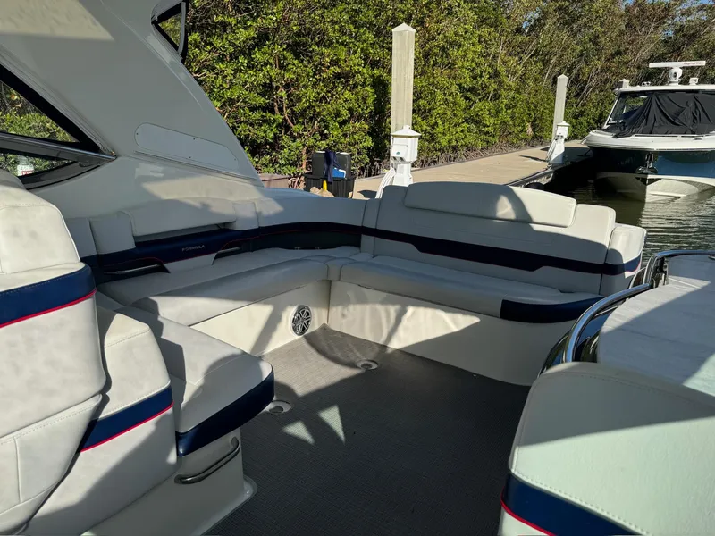 Slide: The Image of 2017 Formula 400 Super Sport boat interior with white seating and blue accents. - 31