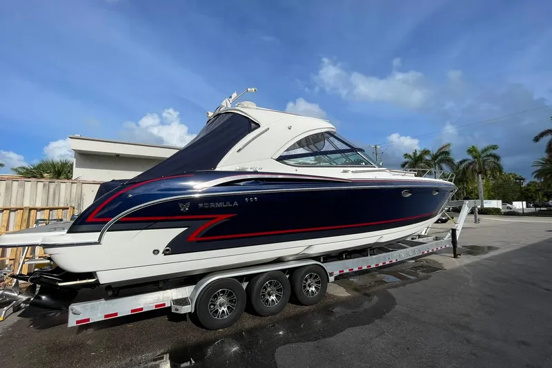 Slide: The Image of 2017 Formula 400 Super Sport boat on trailer, parked outdoors under blue sky. - 5