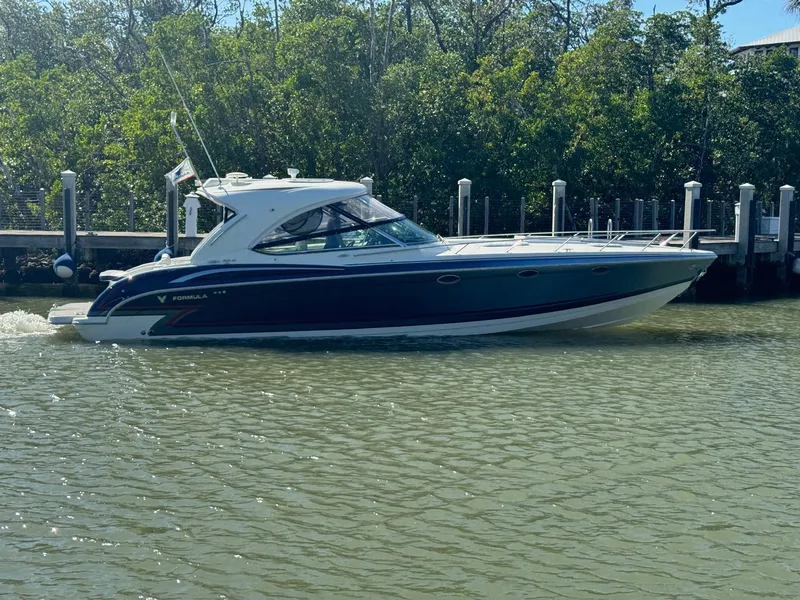 Slide: The Image of 2017 Formula 400 Super Sport boat cruising near a dock. - 7
