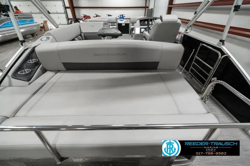 Slide: The Image of 2022 Bennington 22 LSB pontoon boat interior with plush seating in showroom. - 15
