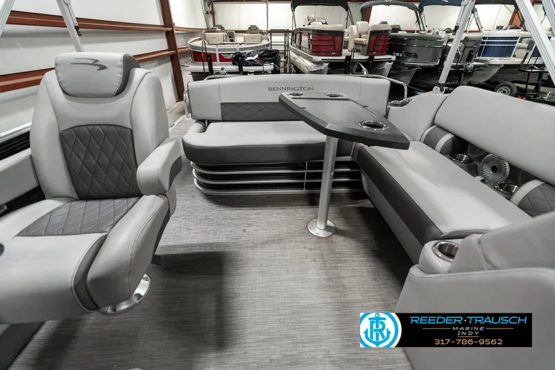 Slide: The Image of 2022 Bennington 22 LSB pontoon boat interior with gray seating and table. - 16