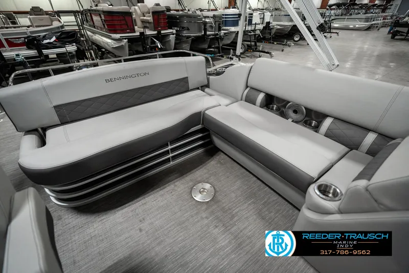 Slide: The Image of 2022 Bennington 22 LSB boat interior with gray seating and cup holders. - 22