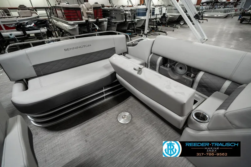 Slide: The Image of 2022 Bennington 22 LSB pontoon boat interior with gray seating and cup holders. - 23
