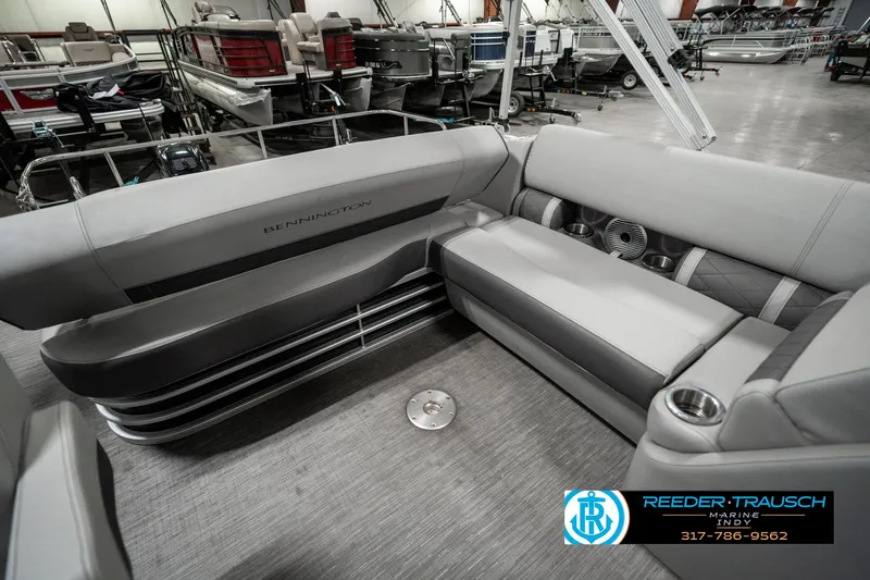 Slide: The Image of 2022 Bennington 22 LSB pontoon boat interior with gray seating and cup holders. - 24