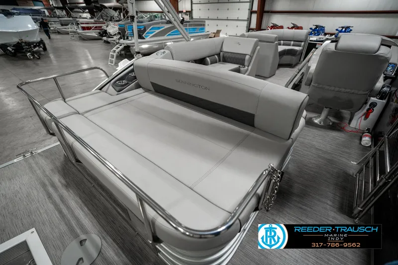Slide: The Image of 2022 Bennington 22 LSB pontoon boat interior with gray seating in showroom. - 25