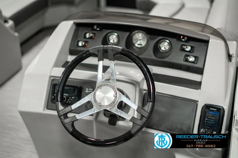 Slide: The Image of Steering wheel and dashboard of a 2022 Bennington 22 LSB boat. - 27