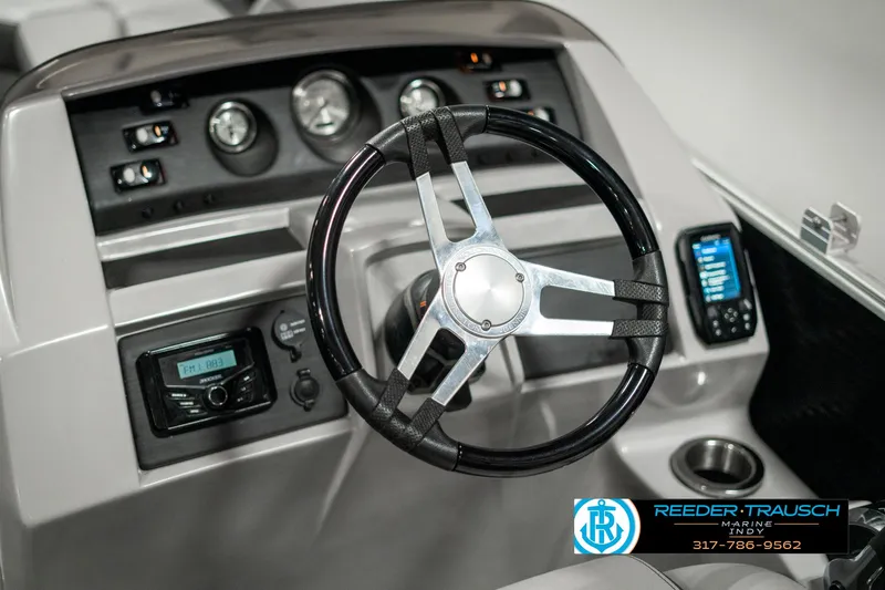 Slide: The Image of 2022 Bennington 22 LSB boat dashboard with steering wheel and control panel. - 28