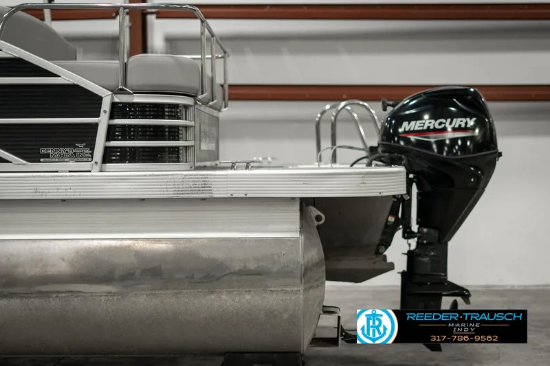 Slide: The Image of 2022 Bennington 22 LSB pontoon boat with Mercury outboard motor in a showroom. - 43