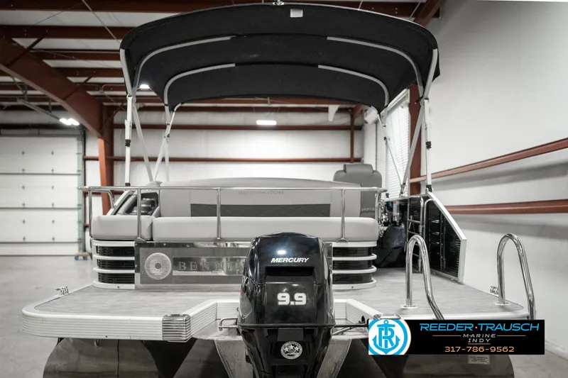 Slide: The Image of 2022 Bennington 22 LSB pontoon boat with Mercury 9.9 motor in a showroom. - 5