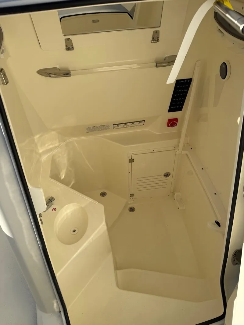 Slide: The Image of 2025 Cobia 265 Open Center Console interior cabin with modern amenities. - 14