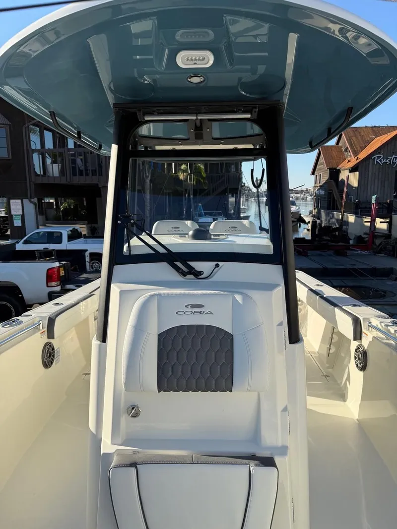 Slide: The Image of 2025 Cobia 265 Open Center Console boat docked in marina. - 15