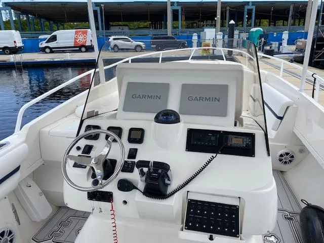 Slide: The Image of 2008 Intrepid 327 Cuddy boat helm with Garmin navigation displays at marina. - 3