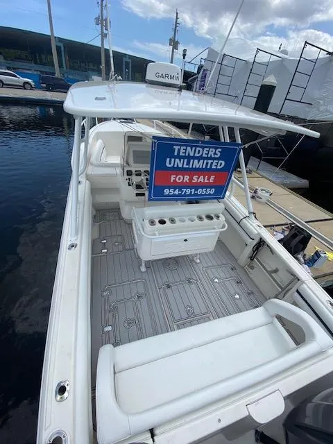 Slide: The Image of 2008 Intrepid 327 Cuddy boat for sale, docked with "Tenders Unlimited" sign. - 4