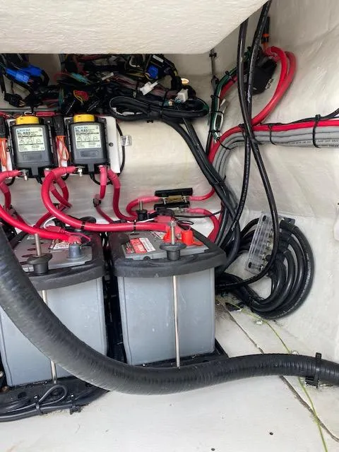 Slide: The Image of 2008 Intrepid 327 Cuddy boat battery compartment with wiring and connections. - 6