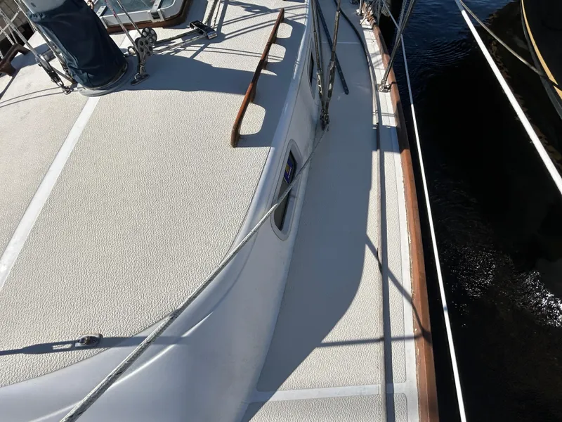 Slide: The Image of 1985 Tartan sailboat deck with textured surface and wooden handrails. - 30