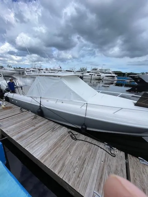 The Image of 2008 Intrepid Cuddy boat docked under cloudy skies. - 0