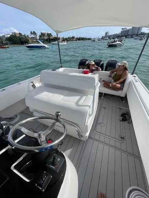 Slide: The Image of 2008 Intrepid Cuddy boat interior with passengers, steering wheel, and scenic water view. - 5